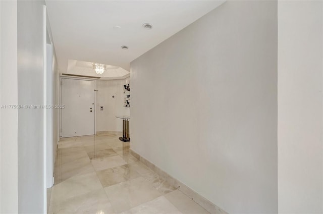 4000 Island Blvd Unit 402, Aventura, FL 33160 - hall featuring baseboards and a chandelier