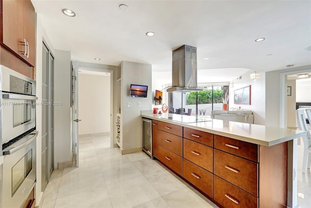 4000 Island Blvd Unit 402, Aventura, FL 33160 - kitchen with black electric stovetop, a peninsula, light countertops, stainless steel double oven, and island range hood