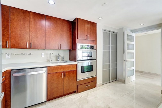 4000 Island Blvd Unit 402, Aventura, FL 33160 - kitchen with recessed lighting, light countertops, a sink, stainless steel appliances, and baseboards
