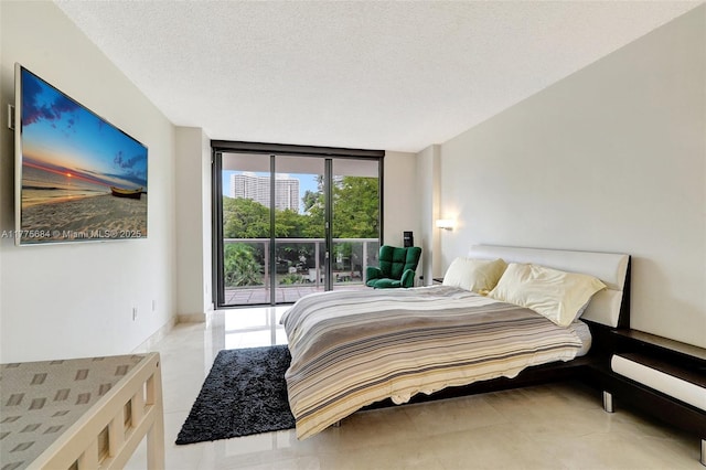 4000 Island Blvd Unit 402, Aventura, FL 33160 - bedroom featuring access to outside, a textured ceiling, and a wall of windows