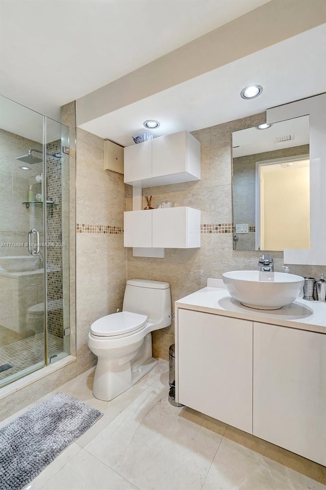4000 Island Blvd Unit 402, Aventura, FL 33160 - full bath featuring a shower stall, vanity, tile patterned flooring, toilet, and tile walls