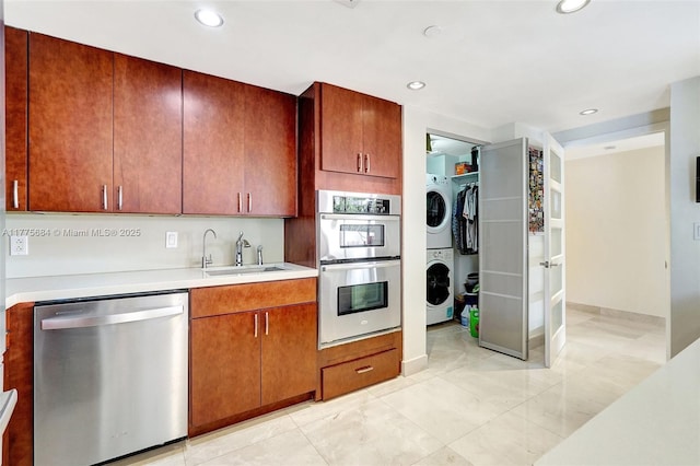 4000 Island Blvd Unit 402, Aventura, FL 33160 - kitchen with a sink, light countertops, appliances with stainless steel finishes, stacked washer and clothes dryer, and recessed lighting