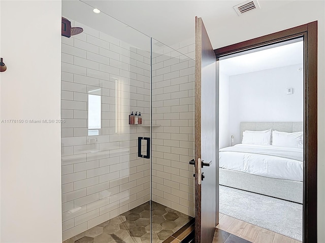 ensuite bathroom with visible vents, a shower stall, and ensuite bath