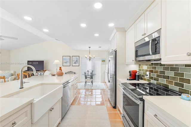 1999 NW 107th Dr, Coral Springs, FL 33071 - kitchen featuring light countertops, a sink, tasteful backsplash, stainless steel appliances, and white cabinets