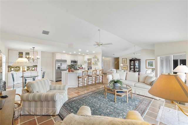 1999 NW 107th Dr, Coral Springs, FL 33071 - living room with vaulted ceiling, light tile patterned floors, ceiling fan with notable chandelier, visible vents, and recessed lighting