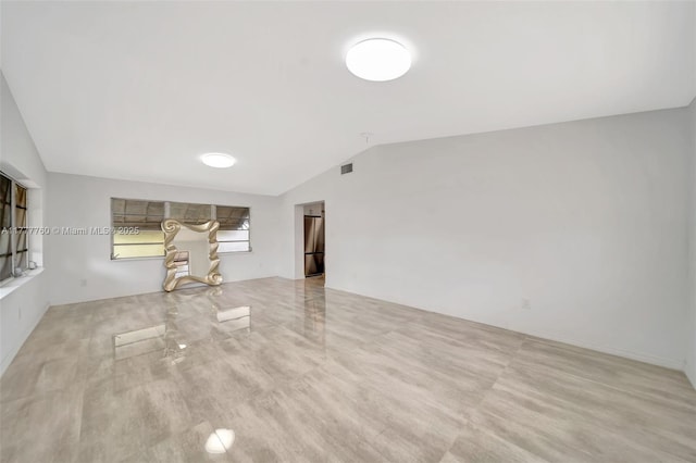 unfurnished living room featuring visible vents and lofted ceiling