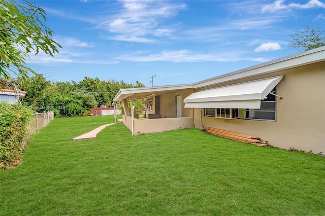 back of property with a yard, a fenced backyard, and stucco siding