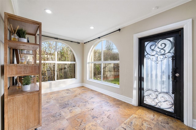 entrance foyer featuring recessed lighting, crown molding, baseboards, and stone tile flooring
