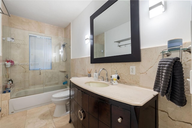 bathroom featuring shower / bathing tub combination, vanity, tile walls, and toilet