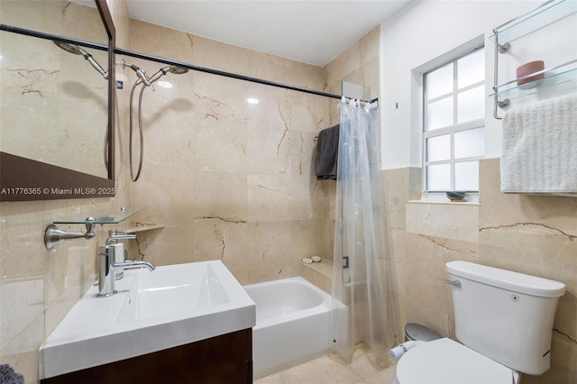 full bath with tile walls, toilet, shower / bath combination with curtain, and vanity