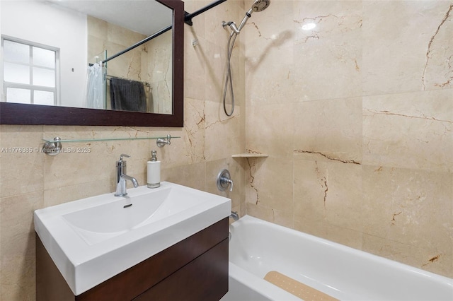 bathroom featuring tile walls, vanity, and shower / bath combination with curtain