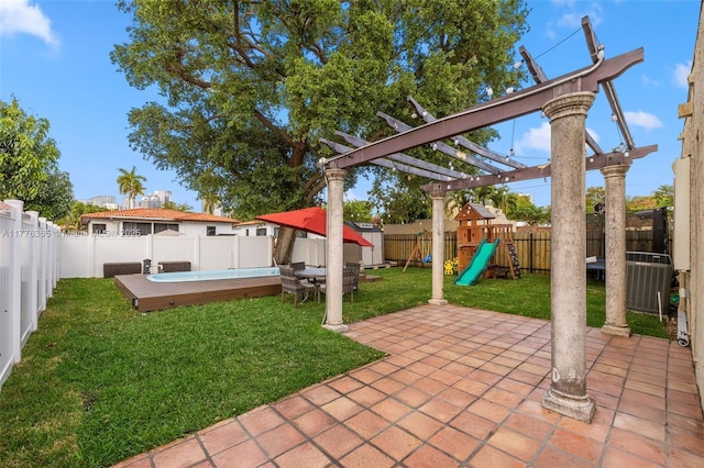view of yard with central AC, a patio area, a fenced backyard, and a playground