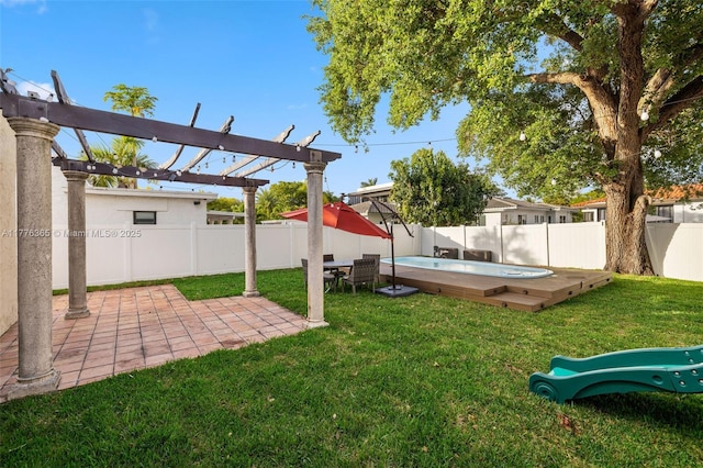 view of yard with a patio area, a hot tub, a pergola, and a fenced backyard