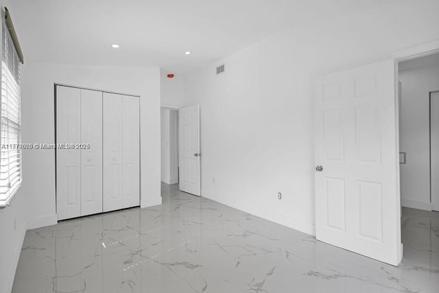 unfurnished bedroom featuring recessed lighting, a closet, marble finish floor, visible vents, and baseboards