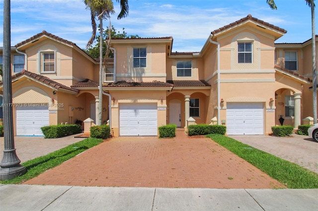 12376 SW 126th Ave Unit 12376, Miami, FL 33186 - view of property with stucco siding, decorative driveway, a tiled roof, and an attached garage