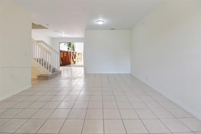 12376 SW 126th Ave Unit 12376, Miami, FL 33186 - empty room with stairway, baseboards, and light tile patterned flooring