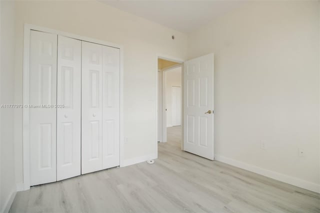12376 SW 126th Ave Unit 12376, Miami, FL 33186 - unfurnished bedroom featuring light wood-style floors, baseboards, and a closet
