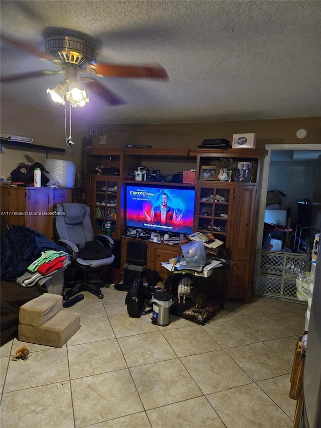 tiled living room featuring a ceiling fan and a textured ceiling