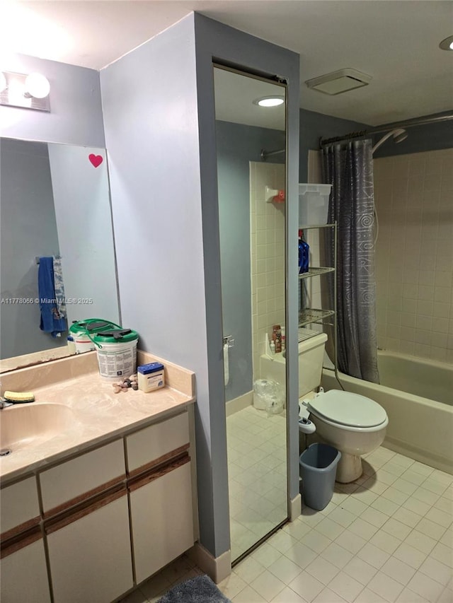 bathroom with vanity, tile patterned flooring, shower / bath combo with shower curtain, and toilet