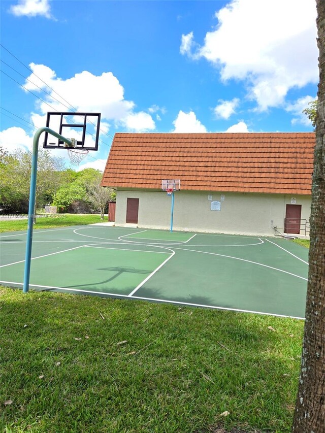 view of basketball court with a yard and community basketball court