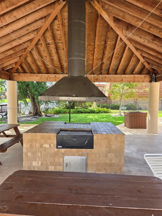 view of patio / terrace featuring a gazebo, exterior kitchen, and fence