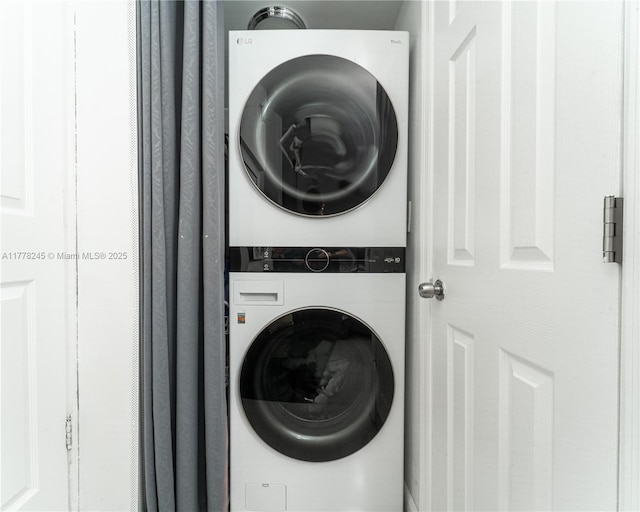 laundry area with stacked washer / dryer and laundry area