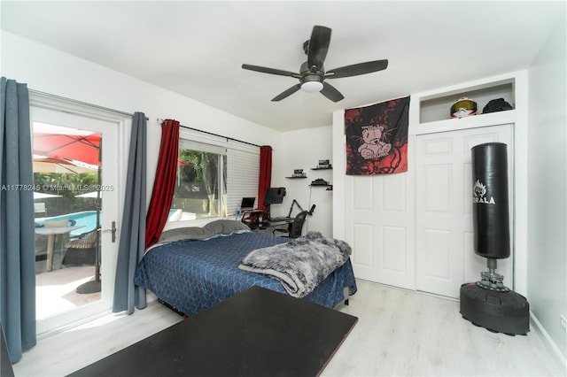 bedroom with ceiling fan, wood finished floors, and access to exterior