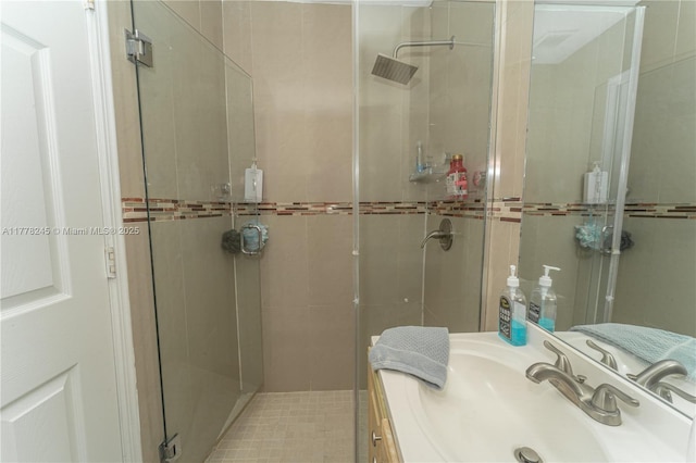 bathroom with vanity and a stall shower