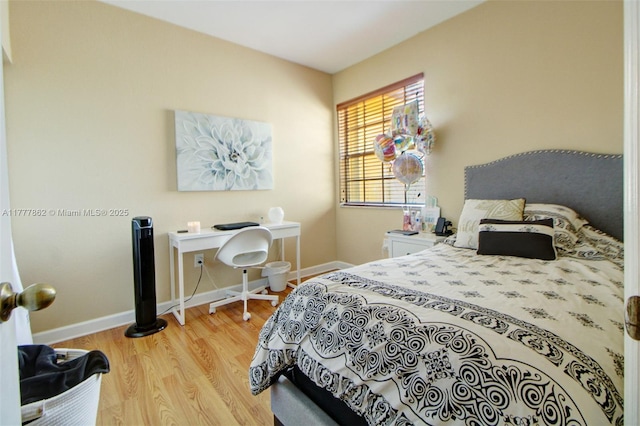 bedroom featuring baseboards and light wood-style flooring