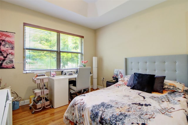 bedroom featuring baseboards and light wood-style flooring