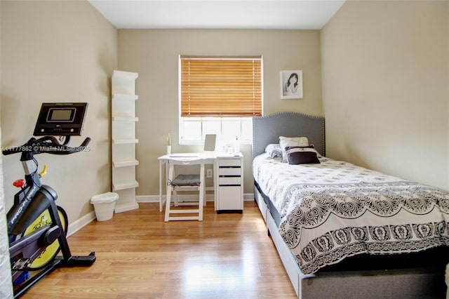 bedroom featuring baseboards and light wood-style floors