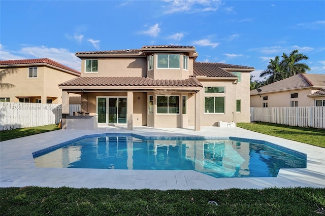 852 Heritage Dr, Weston, FL 33326 - back of house featuring a fenced backyard, stucco siding, a patio area, and a tile roof