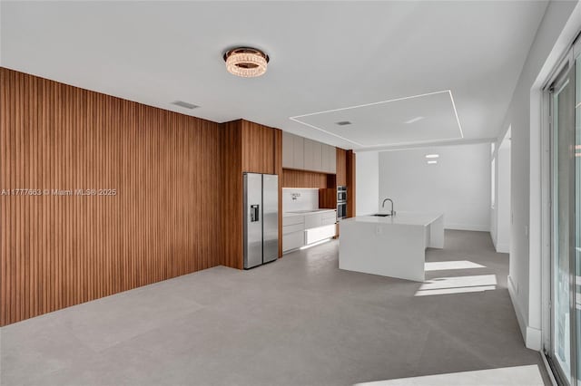 852 Heritage Dr, Weston, FL 33326 - unfurnished living room featuring attic access, a sink, and wooden walls