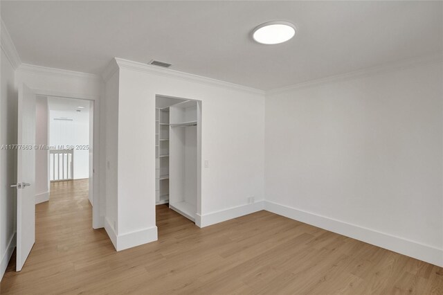 852 Heritage Dr, Weston, FL 33326 - unfurnished bedroom with crown molding, baseboards, light wood-style flooring, and a closet