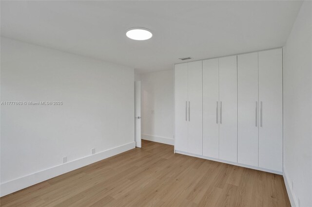852 Heritage Dr, Weston, FL 33326 - unfurnished bedroom featuring light wood-style floors, baseboards, and a closet