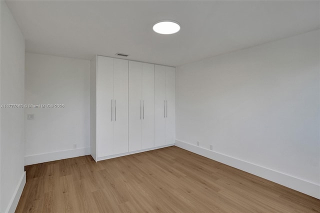 852 Heritage Dr, Weston, FL 33326 - unfurnished bedroom with light wood-style floors, baseboards, and a closet