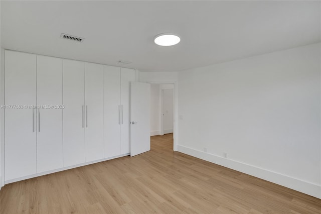 852 Heritage Dr, Weston, FL 33326 - unfurnished bedroom featuring light wood-type flooring, baseboards, and a closet