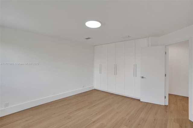 852 Heritage Dr, Weston, FL 33326 - unfurnished bedroom featuring light wood-style floors and a closet