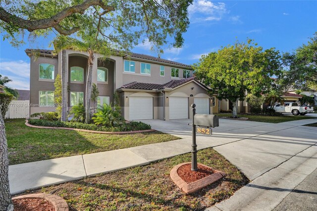 852 Heritage Dr, Weston, FL 33326 - view of front facade with stucco siding, driveway, a tiled roof, and a garage