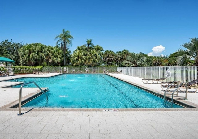 852 Heritage Dr, Weston, FL 33326 - community pool featuring a patio area and view of scattered trees
