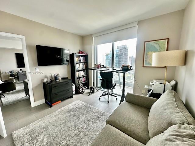 92 SW 3rd St Unit 4104, Miami, FL 33130 - home office featuring wood finished floors, baseboards, and expansive windows