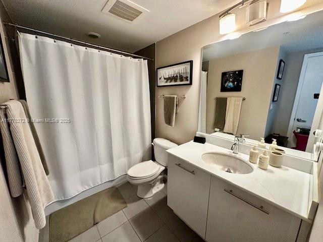92 SW 3rd St Unit 4104, Miami, FL 33130 - bathroom with vanity, tile patterned flooring, toilet, and a shower with curtain