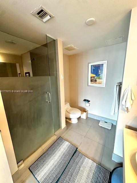 92 SW 3rd St Unit 4104, Miami, FL 33130 - bathroom with toilet, a shower stall, tile patterned floors, and vanity