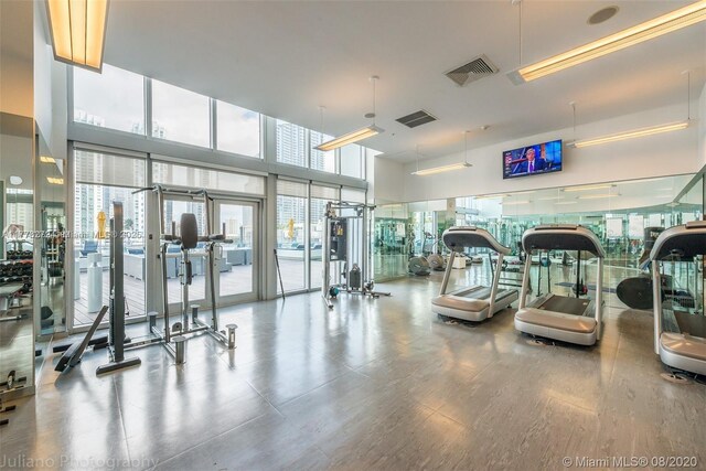 92 SW 3rd St Unit 4104, Miami, FL 33130 - exercise room with wood finished floors and a towering ceiling