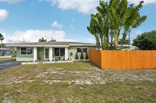 4580 NW 3rd Ave, Oakland Park, FL 33309 - view of front of house with a front yard and fence