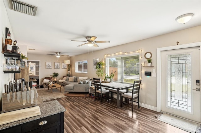 4580 NW 3rd Ave, Oakland Park, FL 33309 - living area with visible vents, baseboards, a ceiling fan, and dark wood-style floors