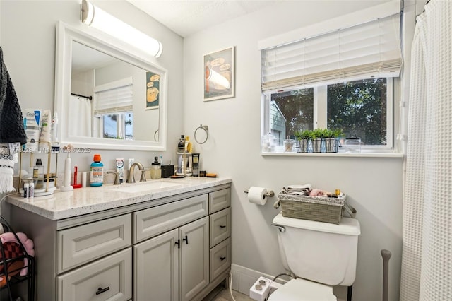 4580 NW 3rd Ave, Oakland Park, FL 33309 - bathroom featuring toilet, vanity, and baseboards
