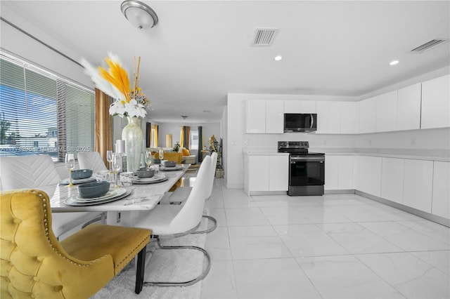dining room featuring visible vents, recessed lighting, and marble finish floor