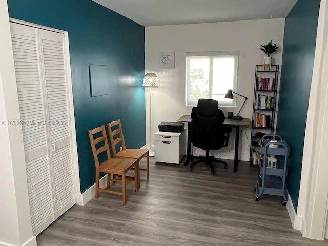 office space with baseboards and wood finished floors
