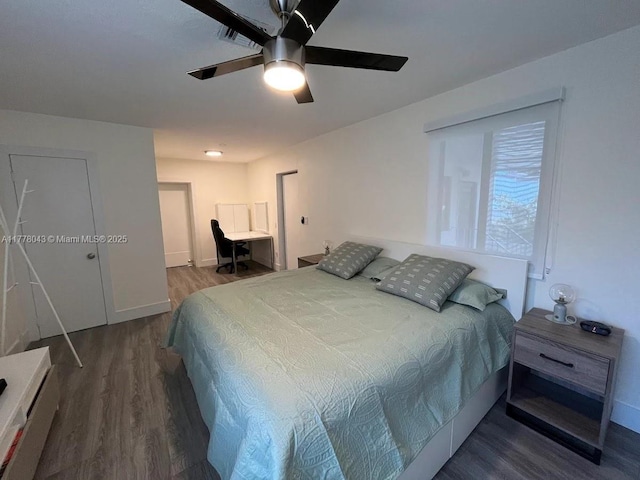 bedroom featuring baseboards, wood finished floors, and a ceiling fan